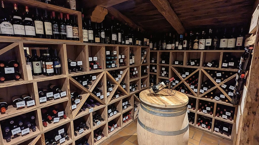 The Adlerkeller wine cellar with a barrel and bottle racks